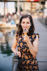 Fototapeta premium Tourist enjoying ice cream cone in genoa italy during summer vacation