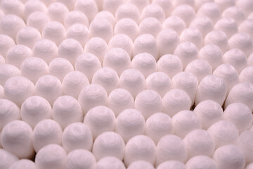 A neatly arranged grid of white cotton swabs