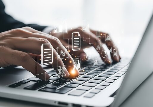 Hands typing on a laptop keyboard with digital data icons overlayed representing information technology and data management