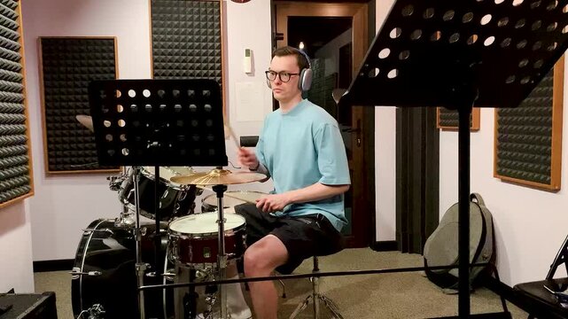 drummer playing in a recording studio .young man asian drummer rehearsing diligently concentrated playing recording studio drums