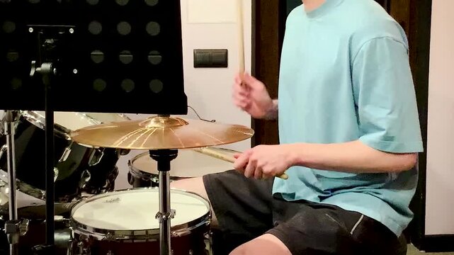 drummer playing in a recording studio .young man asian drummer rehearsing diligently concentrated playing recording studio drums