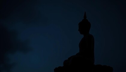 Serene Buddha statue silhouetted against a dark backdrop,  yoga,  zen