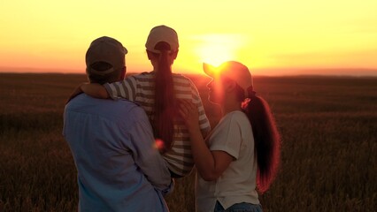 Loving parents baby girl in arms enjoying nature on wheat field in sun. Dad mom child daughter...