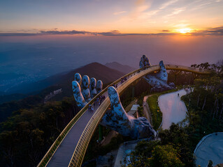 Aerial view Golden bridge at sunset in ba na hills two hands, Da nang Vietnam