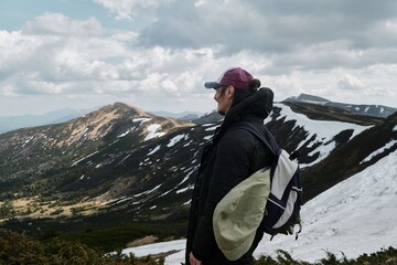 Hiker with Paraglider in Snowy Mountain Landscape