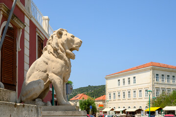 Stone lion in front of the town hall in Pucisca town on the island of Brac. Croatia