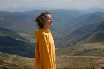Woman in Yellow Jacket Hiking in Carpathian Mountains