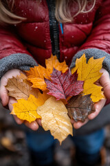 Little girl holding up leaves.