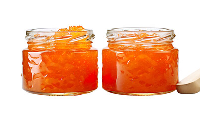 Marmalade in mason jars, with one spoon resting beside them. The jar is filled to the brim and visible from behind