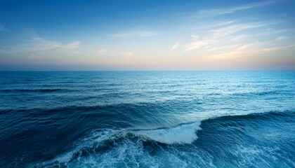 Obraz premium soft blue sea waves under pastel sky during dawn light