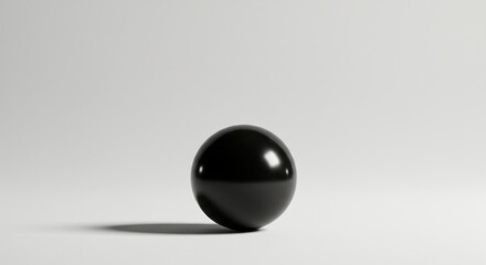 A minimalist monochrome composition of a reflective obsidian sphere on light background