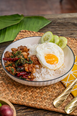 The Stir Fried Spicy Crispy Pork with Basil On Rice and Fried Egg image for  Thai food concept.