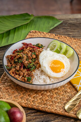 The Stir Fried Spicy Pork with Basil On Rice and Fried Egg image for  Thai food concept.
