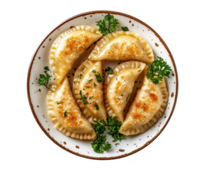 Delicious plate of fried pierogi garnished with fresh parsley on a transparent background