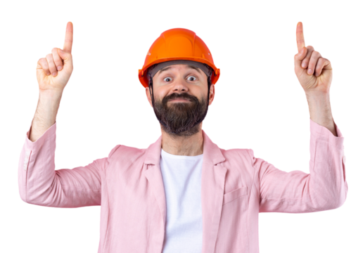 Portrait of young construction engineer wear orange hard hat, in a pink jacket standing on red studio background. The man points with his hand.