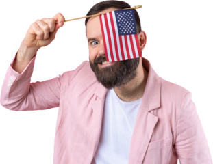 Portrait of a satisfied young man with a beard with an American flag on a red studio background. Great US patriot and defender of freedom.