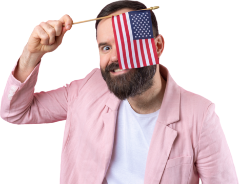 Portrait of a satisfied young man with a beard with an American flag on a red studio background. Great US patriot and defender of freedom.