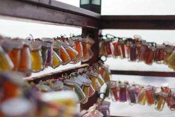 Colorful Mini Bottles Hanging on Wooden Rails
