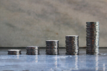 Stacks of coins on black background, business and finance concept.