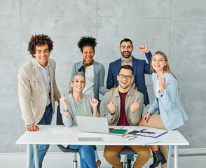 Group portrait of young business team celebrating success  in the office