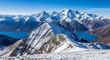 Majestic snow-capped mountain range with vibrant blue lakes beneath clear sky offering