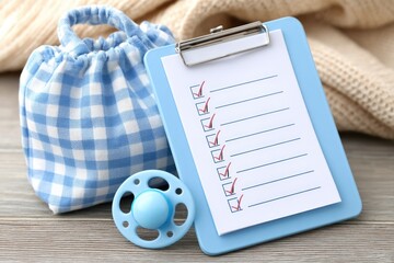 Essential checklist for maternity hospital preparation with baby essentials and pacifier on wooden background