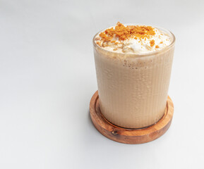 Cold coffee drink frappe frappuccino , with whipped cream and caramel crumble. Salted caramel milkshake with coffee isolated on white background . 