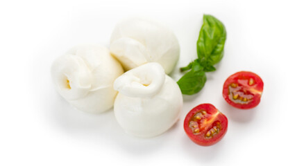 Burrata cheese, tasty Burrata soft cheese with basil leaves and tomatoes on white background, close up. Italian food. Top view