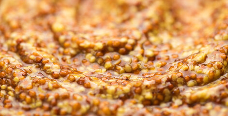 Mustard, French Dijon mustard sauce with whole seeds background. Grainy texture. French pickled mustard seeds sauce texture, close up