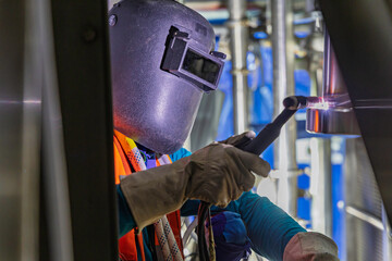 Welding arc argon worker male repaired pipeline stainless chemicals is welding sparks industrial