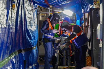 Welding arc argon worker male repaired pipeline stainless chemicals is welding sparks industrial