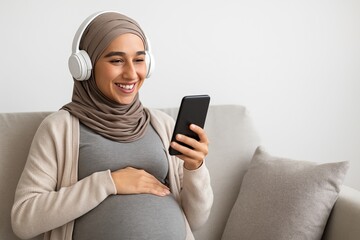 Women in investing audio content empowers through financial education. A pregnant woman wearing a hijab and headphones is smiling while using a smartphone
