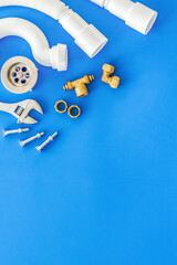 Professional instruments for plumber on blue background top view space for text