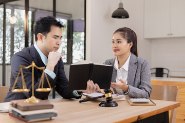 Fototapeta premium Lawyer with Document Paper and Hammer on Wood table, Judge's Gavel, Law, Justice Symbol, Agreement and Partnership Concept,