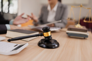 Lawyer with Document Paper and Hammer on Wood table,  Judge's Gavel, Law, Justice Symbol, Agreement and Partnership Concept,