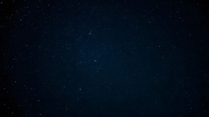Fototapeta premium Starry Night Sky with Scattered Stars Against a Dark Background