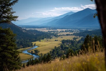 Valley view river winds through meadow surrounded by trees and distant mountains