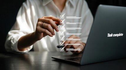 Woman completing tasks on a digital checklist with a stylus on a laptop to-do list task completion