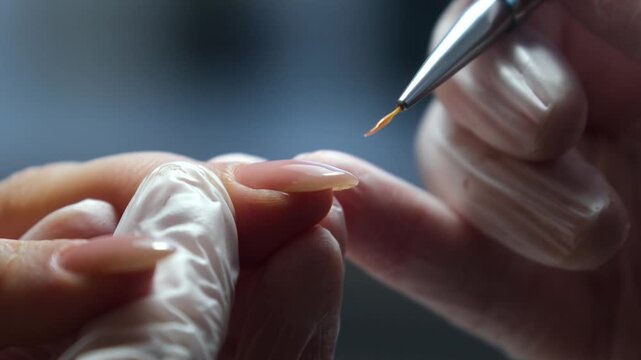 Nail Extension Application: A close-up shot captures the meticulous application of a nail extension, showcasing the precision and artistry involved in creating stunning nails. High quality 4k footage