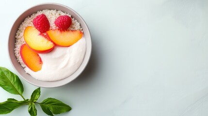 Fresh yogurt bowl with peach and raspberry garnish for a healthy breakfast idea.
