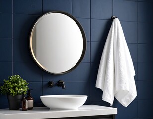 A white towel hanging on a dark navy tiled wall, creating a high contrast, elegant composition. A backlit round mirror and black matte fixtures complete the look.