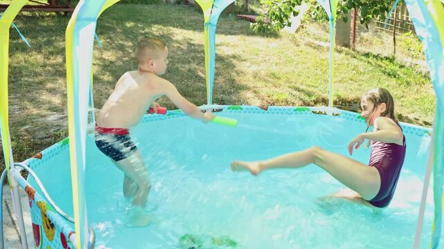 Children playing in the pool. Cute game of brother and sister in the pool. Summer, vacation, enjoyment, fun. Boy with Down syndrome. Inclusion, family.