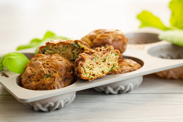 Homemade zucchini pastries on a light wooden table