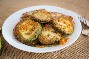 Crispy zucchini slices in sesame on a rustic table