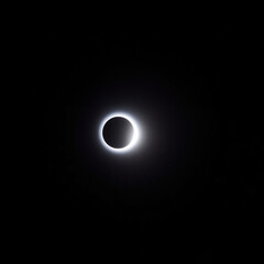 Total solar eclipse with sun's corona visible against black sky  