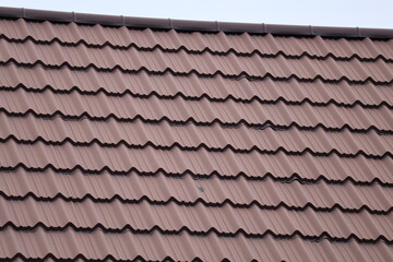 old roof tilesHouse roof with steel roofing sheet. Traditional metal shingle tiles. Gray modular tile effect roof panel. Profiled metallic corrugated pantile as concrete slate. Building's cover