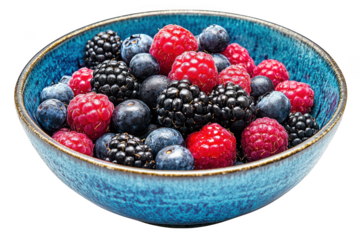 A vibrant blue bowl filled with fresh raspberries blueberries and blackberries isolated on transparent background