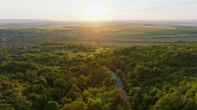 Medieval Balkan fortress Ovech captured from drone in summer, located above Provadia Bulgaria, stone tower, wooden walkway, forest-covered ridge, travel destination with cultural architecture