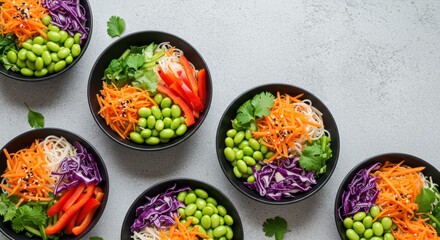 Overhead view of vibrant noodle bowls with fresh vegetables for a healthy vegan meal