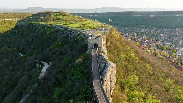 Scenic Balkan fortress Ovech in Bulgaria during summer, drone aerial perspective, ancient hilltop ruins above Provadia, stone entrance gate, popular travel site with cultural and medieval history